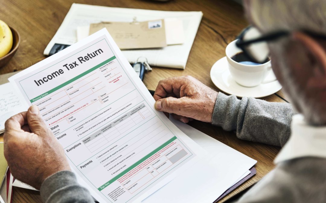 A man looking over his tax return which his accountant opted to extend the deadline of