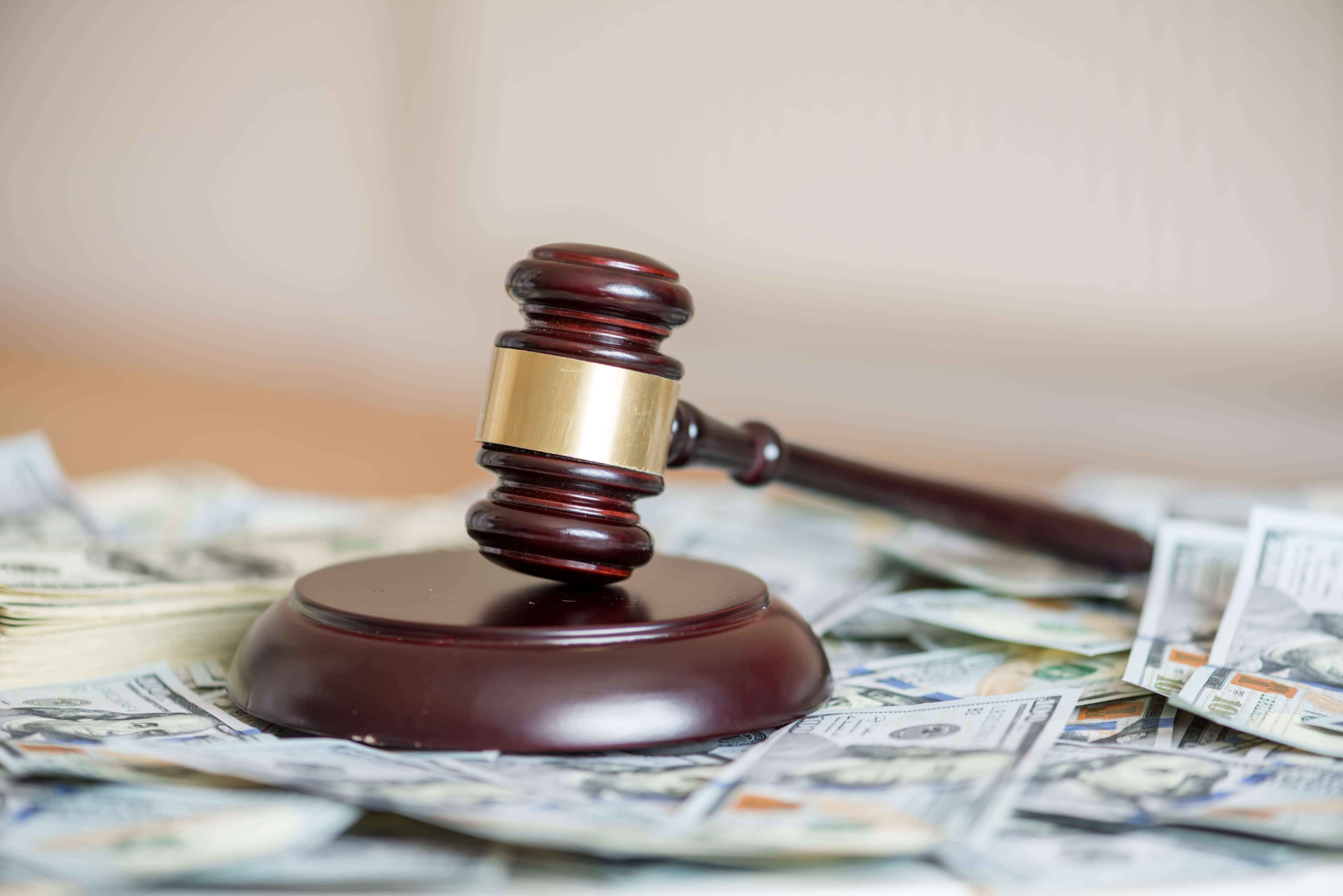 A gavel sitting over a pile of money to represent the decision to waive taxpayer penalties for 2018